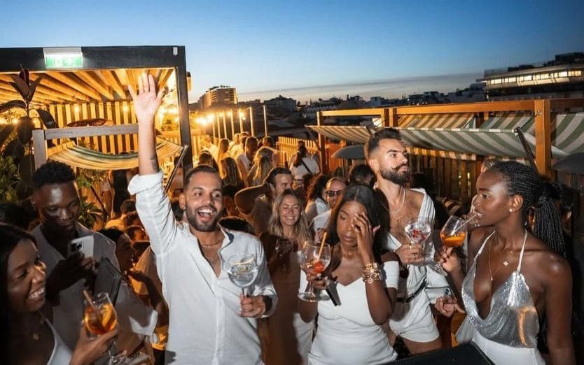 Rooftop party crowd at sunset in Barcelona